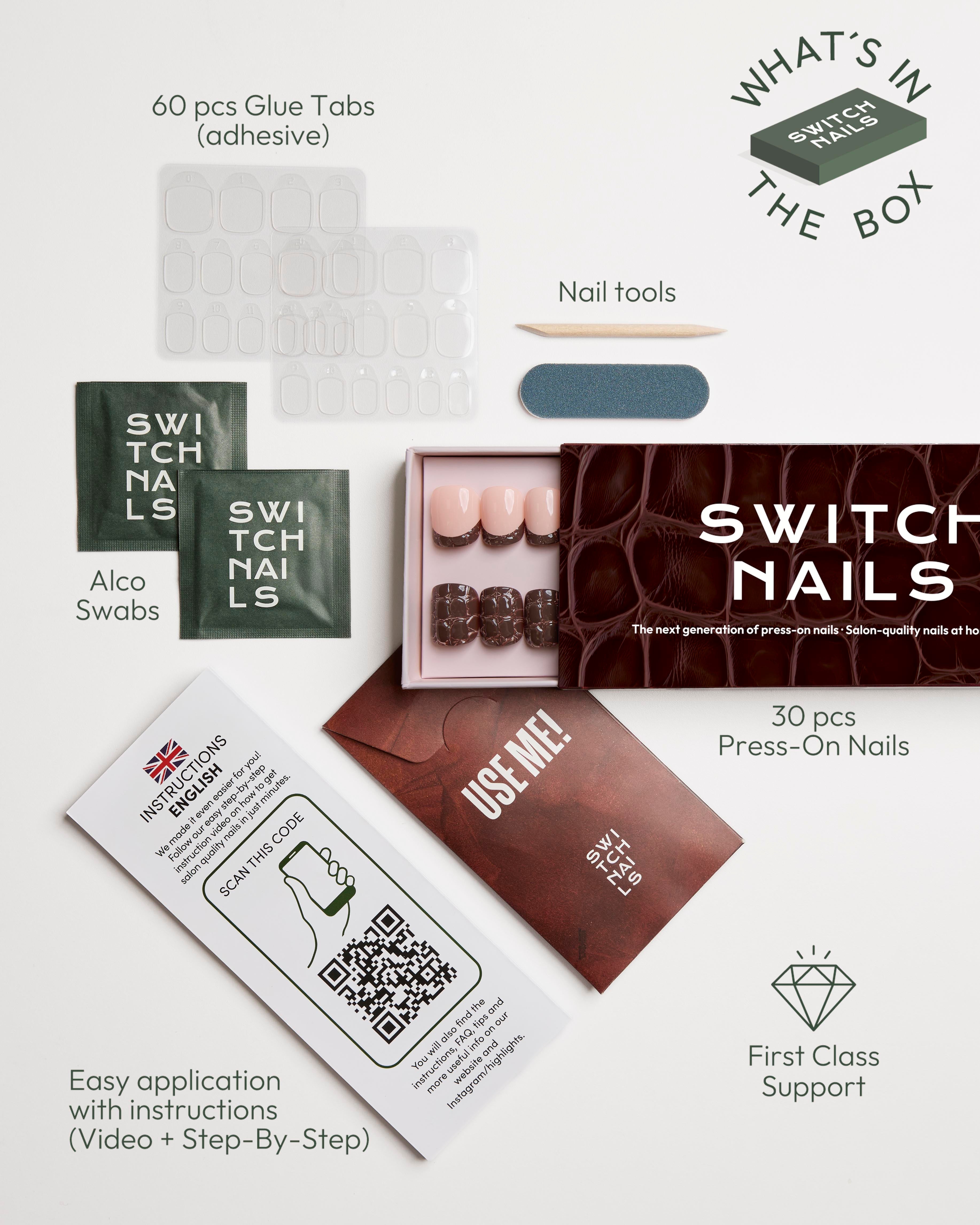 A flat-lay product presentation of the Switch Nails Press-On Nail Kit on a clean white background, showing the contents of the box including false nails, adhesive glue tabs, alcohol swabs, nail tools, and an application card with instructions.